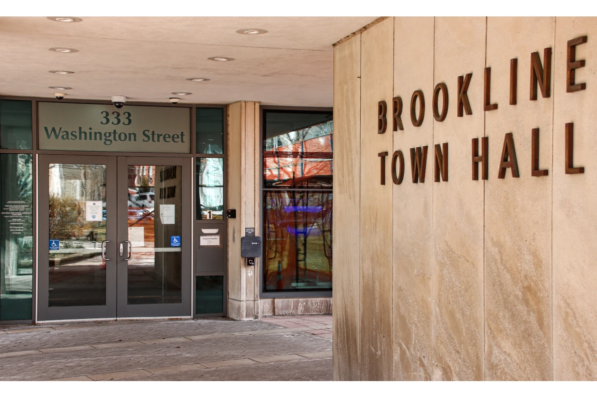 The front of Brookline Town Hall, a stone building.