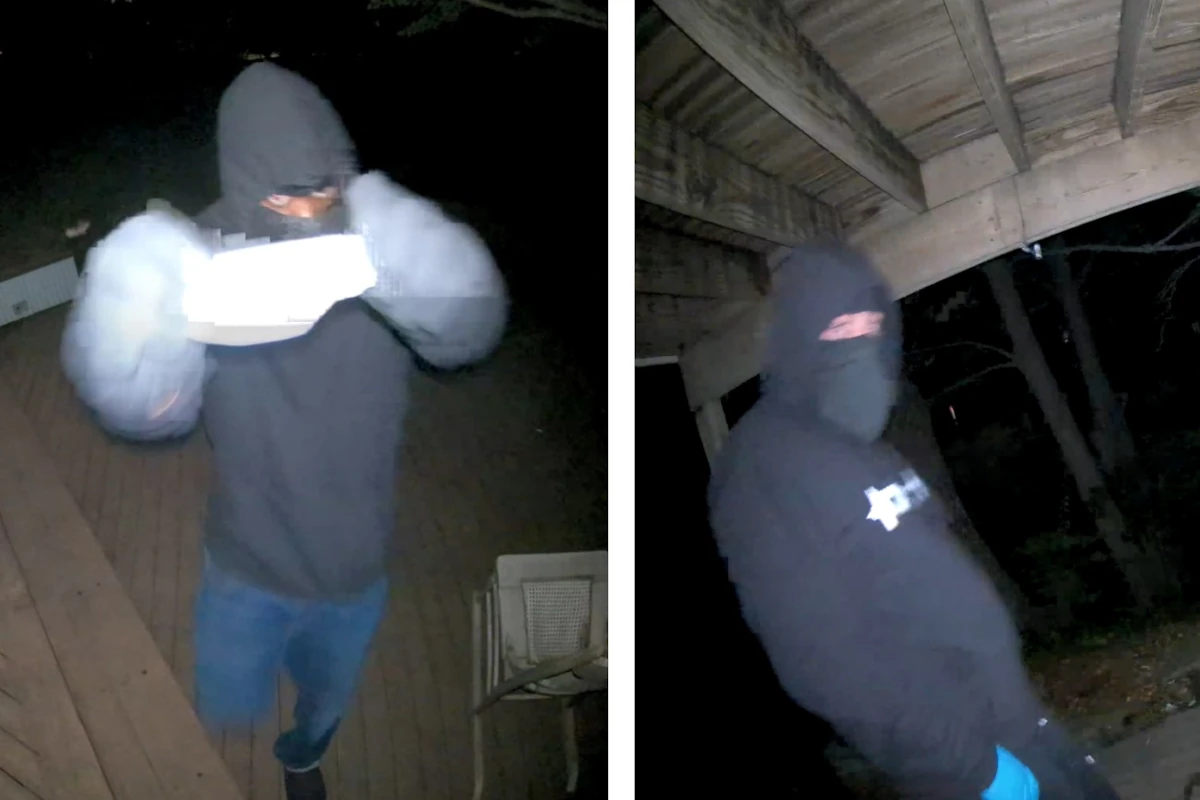 Two men wearing masks and dark clothing seen on video surveillance footage.